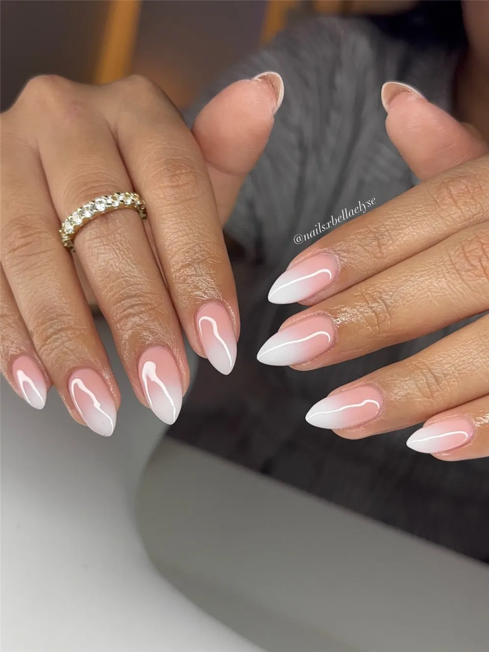 Almond nails with a soft pink to white ombre finish