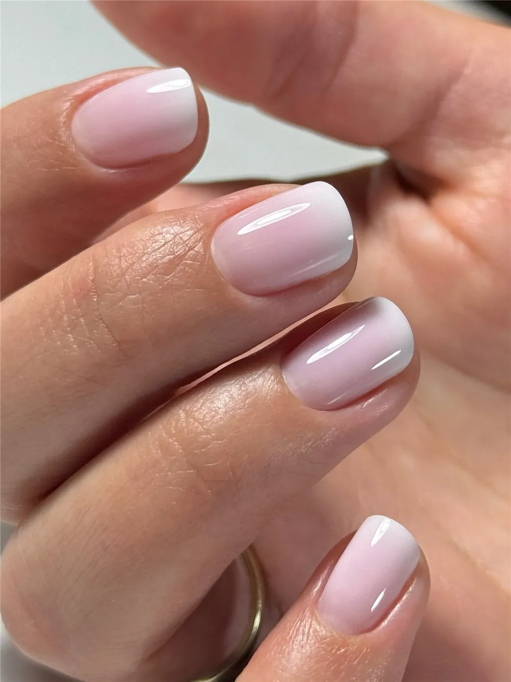 Glossy milky white short nails with a rounded square shape