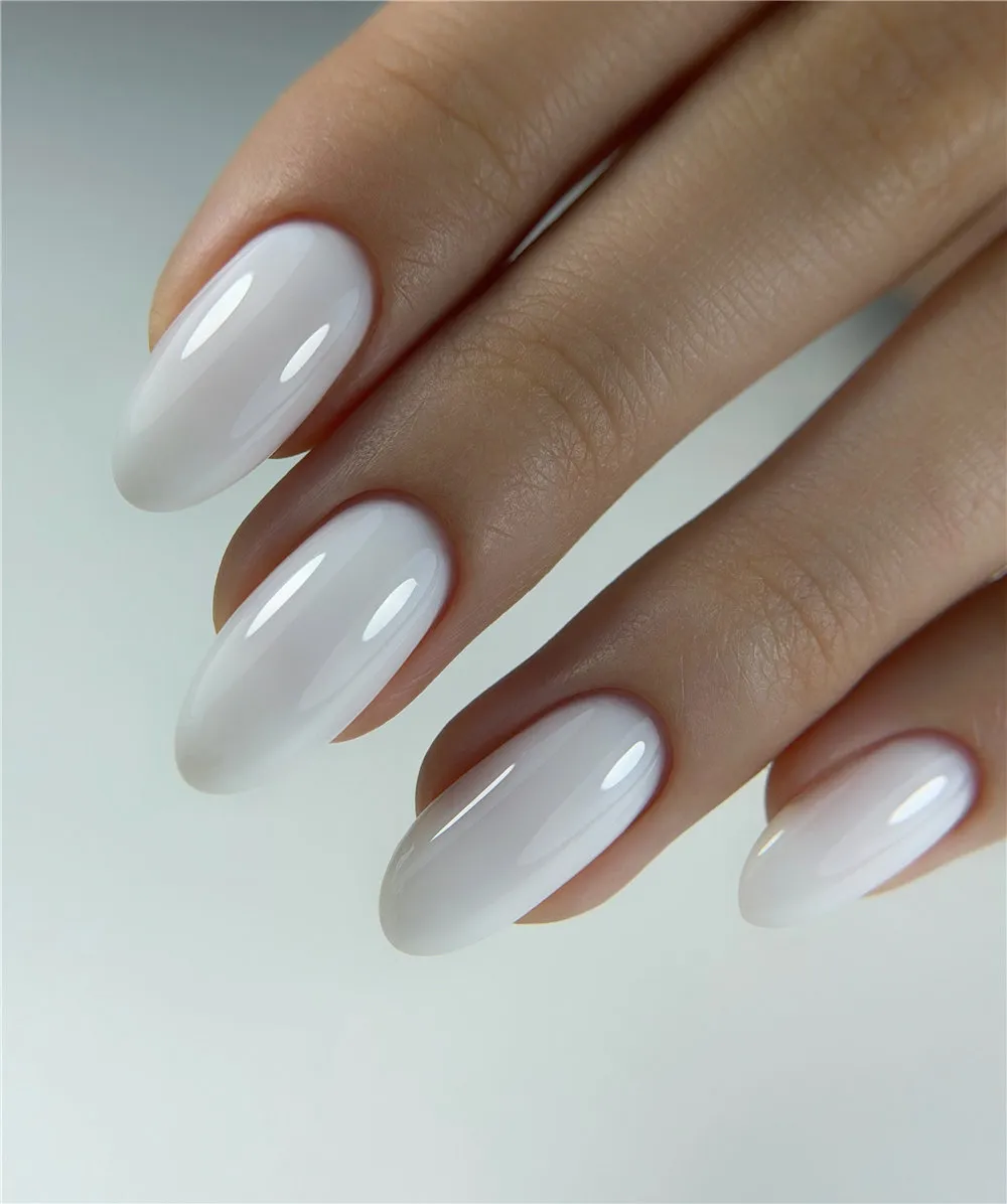 Long glossy white oval nails with a sheer milky finish