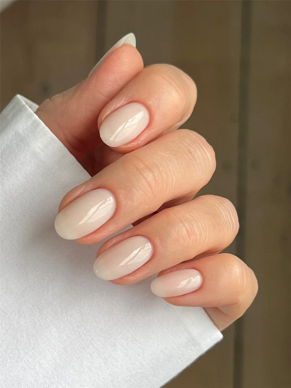 Natural oval nails with glossy milky white polish