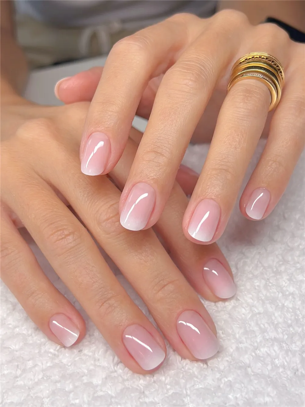 Short nails with a soft pink to white ombre manicure