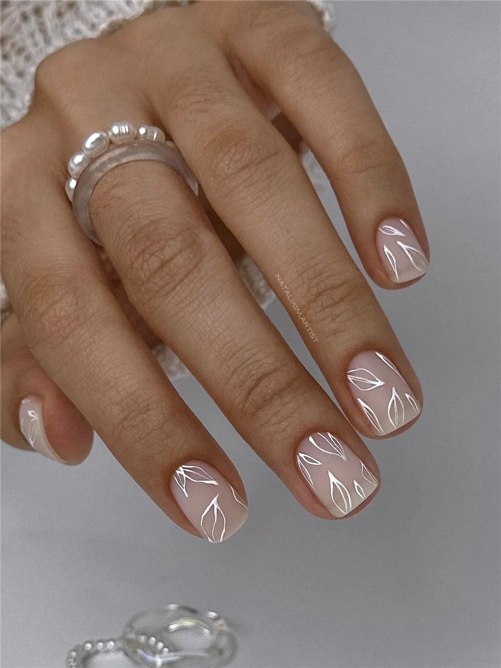 Short nude nails with fine white leaf line art