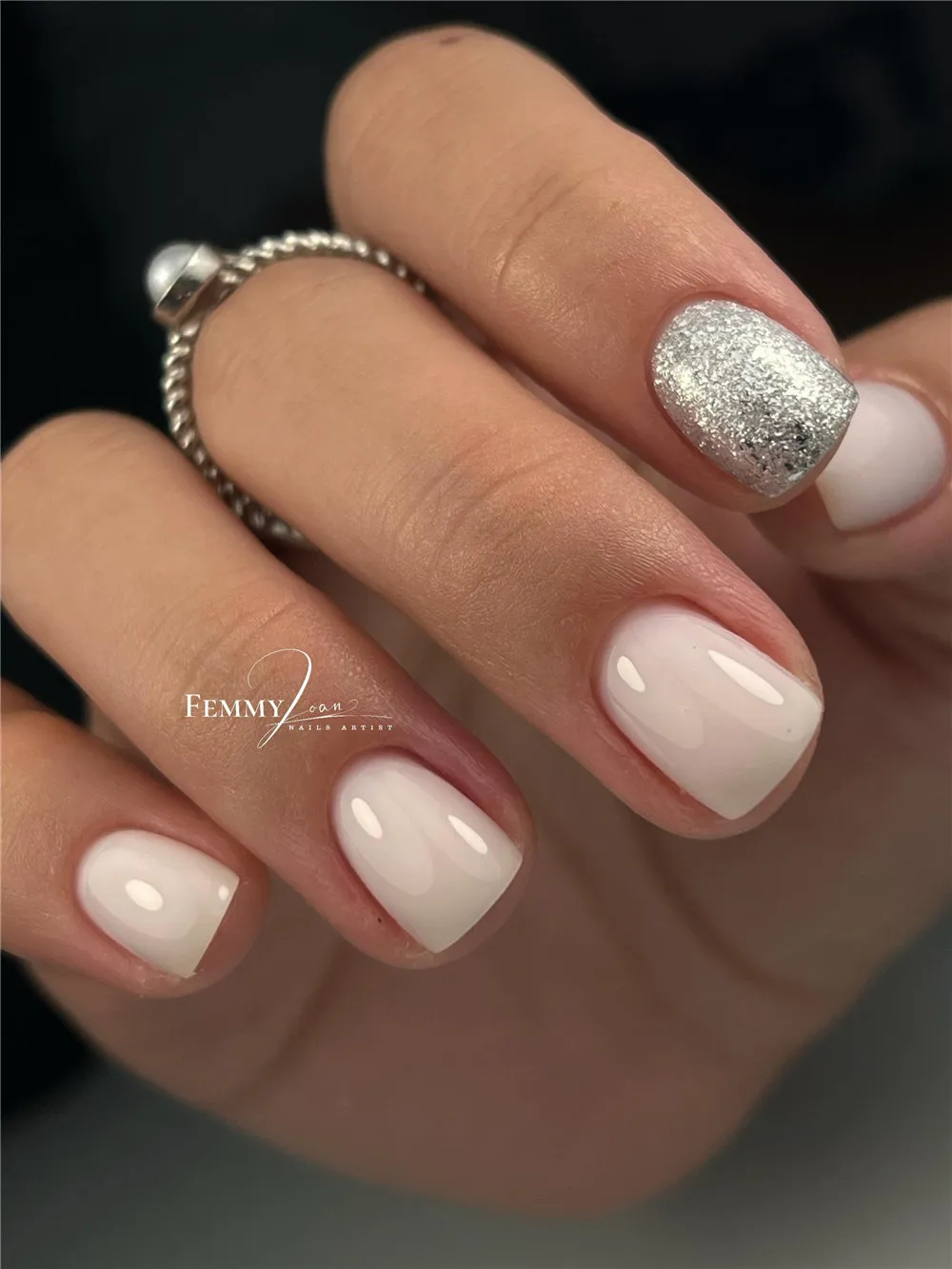Short white nails with one silver glitter accent nail