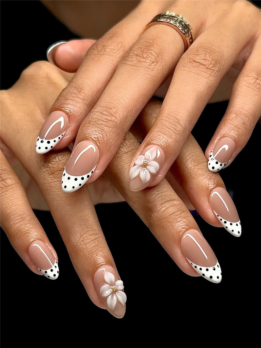 Almond nails with white polka dot French tips and 3D flower accents
