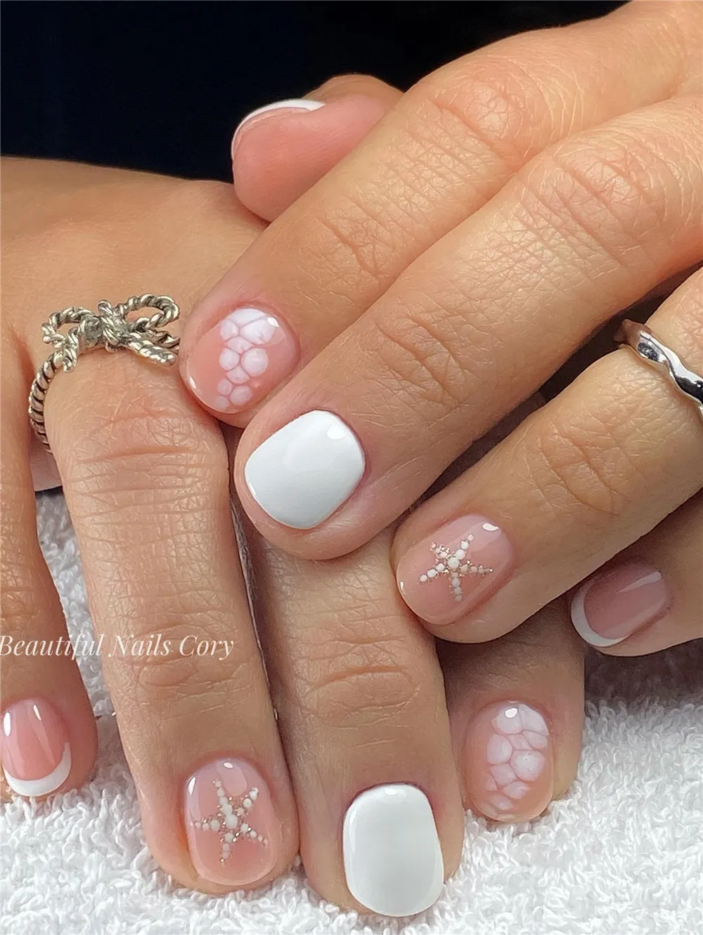 Short white beach nails with pearl starfish, shell scale details, and French tips