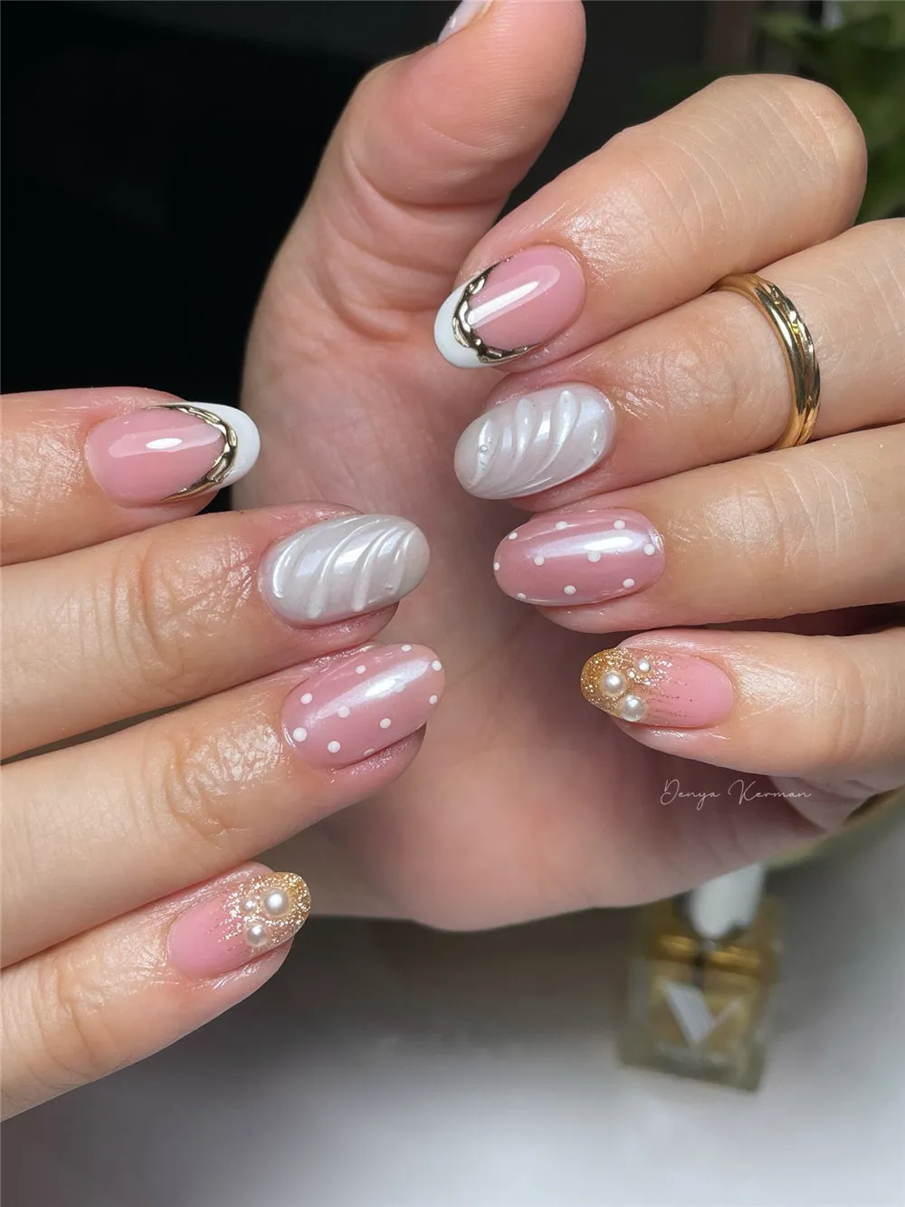 White French nails with raised shell texture, pearls, gold accents, and polka dots